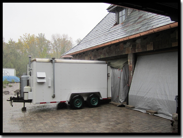 Concrete Renewal's proprietary climate control trailer set up at a Minneapolis residence to manage humidity and dew points, ensuring a 'perfect bond' for Poly-Quartz garage floor coatings 365 days a year regardless of Minnesota weather.